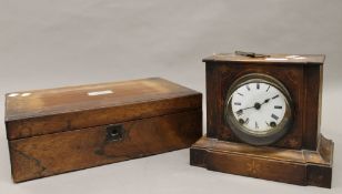 A Victorian rosewood writing slope and a Victorian inlaid mantle clock. The clock 21.5 cm high.