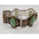 A Chinese silver and enamel five stone apple jade bracelet. Approximately 16 cm long.