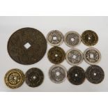 A quantity of Chinese coins and a disc. Coins 3.25 cm diameter; disc 7 cm diameter.