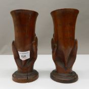 A pair of carved treen souvenirs from Pitcairn vases. Each 17 cm high.