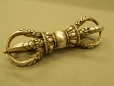 A silver vajra. 9.5 cm long.