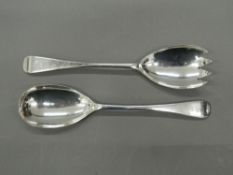 A pair of silver salad servers.
