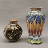 Two florally decorated vases. The largest 31 cm high, smaller 19 cm high.