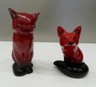 Two Royal Doulton Flambe models, a fox and a cat. The cat 13 cm high.