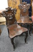 A pair of Victorian mahogany hall chairs, the backs each set with a carved ostrich. 92 cm high.