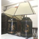 Two tea tin form table lamps. 51 cm high (excluding shades).