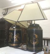 Two tea tin form table lamps. 51 cm high (excluding shades).