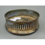 Two plated coasters and a snuffer. Coasters 11 cm diameter; snuffer 19 cm long.