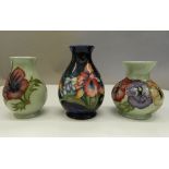 Three small Moorcroft vases. The largest 11 cm high.
