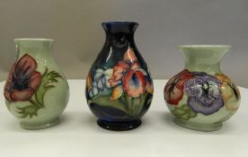 Three small Moorcroft vases. The largest 11 cm high.