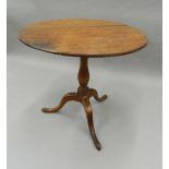 A 19th century oak and mahogany tripod table. 75 cm diameter.