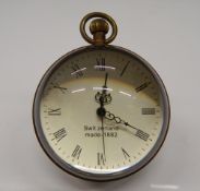 A small ball clock. 8 cm high.