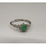 A jade and cubic zirconia ring.