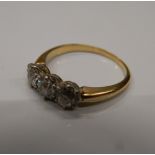 An unmarked gold three stone diamond ring. Ring size K (2.
