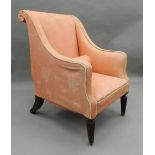 A 19th century upholstered armchair. 68 cm wide.