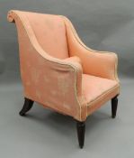 A 19th century upholstered armchair. 68 cm wide.