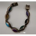 A silver multi stoned bracelet. 16 cm long (25.
