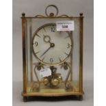 A four ball brass Anniversary clock. 21 cm high.