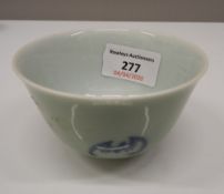 A Chinese celadon tea bowl decorated with bats. 5.5 cm high; 9 cm diameter.