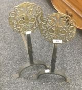 A pair of brass mounted iron fire dogs. 51 cm high.