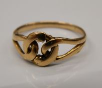 A 9 ct gold lover's knot ring. Ring size L/M (2.2 grammes).