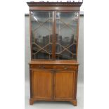 An Edwardian mahogany bookcase cabinet. 105 cm wide.