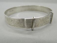 An engraved silver bangle (12.7 grammes).