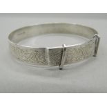 An engraved silver bangle (12.7 grammes).