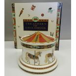 A boxed Royal Crown Derby Treasures of Childhood Carousel Money Box. 11.5 cm diameter.