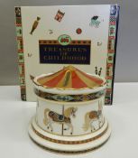 A boxed Royal Crown Derby Treasures of Childhood Carousel Money Box. 11.5 cm diameter.