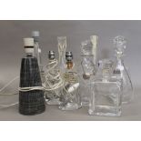 A quantity of various decanters and glass table lamps. Pair of lamps 22 cm high.