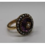 An unmarked gold, possibly 18 ct gold, pearl and amethyst elaborately worked circular form ring,