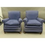 A pair of early 20th century upholstered armchairs. 85 cm wide.