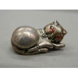 A silver brooch formed as a cat. 3 cm long (8.