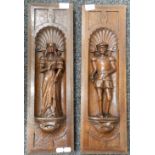 A pair of 19th century carved oak panels depicting a male and female figure. Each 18 x 58.5 cm.