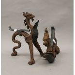 A pair of late 18th/early 19th century bronze and cast iron fire dogs formed as dragons. 27.