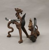 A pair of late 18th/early 19th century bronze and cast iron fire dogs formed as dragons. 27.