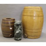 Two stoneware spirit barrels and a small marble column. The latter 22.5 cm high.