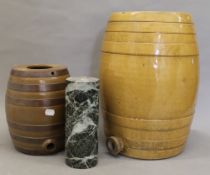 Two stoneware spirit barrels and a small marble column. The latter 22.5 cm high.