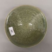 A Chinese celadon ground pottery bowl. 18.5 cm diameter.