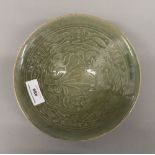 A Chinese celadon ground pottery bowl. 18.5 cm diameter.