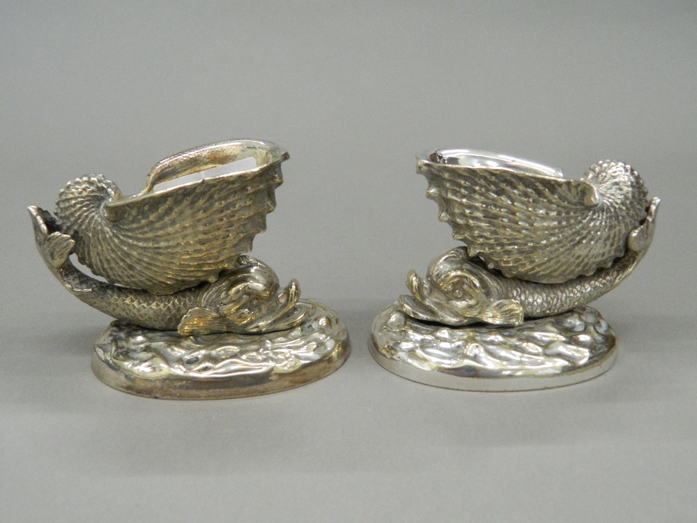 A pair of silver plated dolphin form table salts. 7.5 cm high.