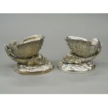 A pair of silver plated dolphin form table salts. 7.5 cm high.