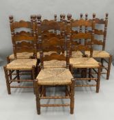 Eight ladder back rush seated chairs. 118 cm high.