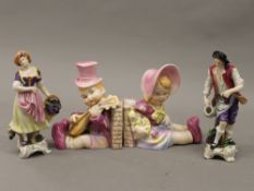 A pair of Continental figures and a pair of figural porcelain bookends. The largest 16 cm high.