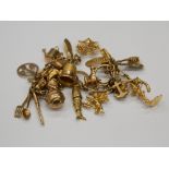 A small 9 ct gold charm bracelet set with various charms (34.3 grammes).