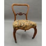 A Victorian walnut nursing chair. 73 cm high.