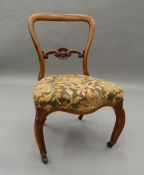 A Victorian walnut nursing chair. 73 cm high.