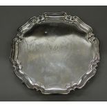 A silver salver. 26 cm diameter (17.4 troy ounces).