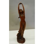 An Art Nouveau style wooden figure of a girl. 23 cm high.